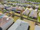 An aerial view showcases the arrangement of homes, backyards, and landscaping in a residential neighborhood at 5147 Brickwood Rise Dr, Wimauma, FL 33598