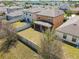 Aerial backyard showcases a fenced lawn and screened porch, bordered by neighboring houses at 5147 Brickwood Rise Dr, Wimauma, FL 33598