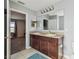 Bathroom with double sink vanity, and a large mirror at 5147 Brickwood Rise Dr, Wimauma, FL 33598