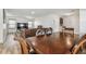 Elegant dining area with a wooden table and chairs, flowing into an open living room and kitchen at 5147 Brickwood Rise Dr, Wimauma, FL 33598