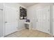 Clean entryway featuring tile flooring and white doors, accented by modern wall decor and a fish tank at 5147 Brickwood Rise Dr, Wimauma, FL 33598
