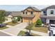 Two-story home showcasing a well-manicured lawn, mulched flower beds, and an attached two-car garage at 5147 Brickwood Rise Dr, Wimauma, FL 33598