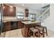 Bright kitchen with a center island, dark cabinets, granite countertops, and stainless steel appliances at 5147 Brickwood Rise Dr, Wimauma, FL 33598