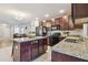 Modern kitchen with granite counters, a center island, stainless steel appliances, and tile flooring at 5147 Brickwood Rise Dr, Wimauma, FL 33598