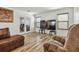 Bright living room with wood floors, a large TV, and comfortable seating, perfect for relaxation at 5147 Brickwood Rise Dr, Wimauma, FL 33598