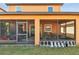 Exterior view of screened patio area with dark metal frames, next to large backyard at 5147 Brickwood Rise Dr, Wimauma, FL 33598