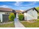 Cozy villa featuring a well-manicured front yard and an inviting entryway at 5310 Bellefield Dr, Tampa, FL 33624