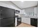 Modern kitchen featuring granite countertops, white cabinets, and black appliances at 5310 Bellefield Dr, Tampa, FL 33624