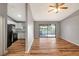 Open living space with hardwood floors, black appliances, and pond views at 5310 Bellefield Dr, Tampa, FL 33624