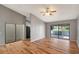 Bright living room featuring hardwood floors, ceiling fan, and a serene lake view at 5310 Bellefield Dr, Tampa, FL 33624
