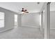 Spacious main bedroom featuring neutral carpeting, a ceiling fan, and closet at 5310 Bellefield Dr, Tampa, FL 33624