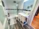 Updated bathroom featuring a shower over bath with glass screen and vanity with storage at 5712 Biscayne Ct # 203, New Port Richey, FL 34652