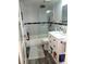 Updated bathroom featuring a shower over bath with glass screen and vanity with storage at 5712 Biscayne Ct # 203, New Port Richey, FL 34652