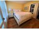 Bright bedroom with hardwood floors, a comfortable bed, and ample natural light at 5712 Biscayne Ct # 203, New Port Richey, FL 34652