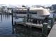 A boat lift with a boat on top of it is next to a composite dock at 5712 Biscayne Ct # 203, New Port Richey, FL 34652