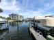 View of a boat lift and dock shows the waterfront condo buildings at 5712 Biscayne Ct # 203, New Port Richey, FL 34652