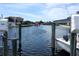 Boats rest on boat lifts in a canal at 5712 Biscayne Ct # 203, New Port Richey, FL 34652