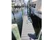 Dock pilings and a gray composite walking surface are shown at 5712 Biscayne Ct # 203, New Port Richey, FL 34652