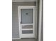 Apartment 203 featuring a white framed storm door with screen and white trim at 5712 Biscayne Ct # 203, New Port Richey, FL 34652