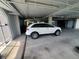 Garage parking area with a white SUV shows available parking at 5712 Biscayne Ct # 203, New Port Richey, FL 34652