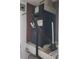A modern HVAC unit sits atop a tiled platform, surrounded by utility connections at 5712 Biscayne Ct # 203, New Port Richey, FL 34652