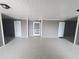 Well-lit hallway with gray painted walls and doors that lead to apartments at 5712 Biscayne Ct # 203, New Port Richey, FL 34652