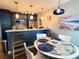 Cozy kitchen with adjacent dining area featuring modern lighting and stylish decor at 5712 Biscayne Ct # 203, New Port Richey, FL 34652
