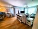 Open concept living area featuring wood floors, comfortable seating, and stylish coastal décor at 5712 Biscayne Ct # 203, New Port Richey, FL 34652