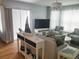 Bright and airy living room with sliding glass doors, stylish furniture, and beachy décor at 5712 Biscayne Ct # 203, New Port Richey, FL 34652