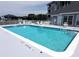 Sparkling community swimming pool with ample lounge seating and shaded areas at 5712 Biscayne Ct # 203, New Port Richey, FL 34652