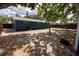 The backyard features mature trees that provide shade and a partial fence line for privacy at 5806 12Th S Ave, Tampa, FL 33619