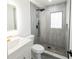 Stylish bathroom with modern vanity, toilet, and walk-in shower with glass-block window for natural light at 5806 12Th S Ave, Tampa, FL 33619