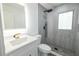 Elegant bathroom featuring modern vanity, toilet, and a glass-block window shower at 5806 12Th S Ave, Tampa, FL 33619