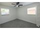 A bright, empty bedroom showcasing neutral walls, tile floors, and new ceiling fan with natural light at 5806 12Th S Ave, Tampa, FL 33619