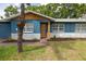 Charming single-story home with blue paint, white stone accents, and a modern front door at 5806 12Th S Ave, Tampa, FL 33619