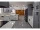 Updated kitchen featuring gray and white cabinets, stainless steel appliances, and quartz countertops at 5806 12Th S Ave, Tampa, FL 33619
