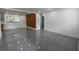 Bright living room featuring stylish gray tile flooring and contemporary wood accent wall at 5806 12Th S Ave, Tampa, FL 33619