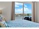 Inviting bedroom featuring a private balcony, waterfront views, and plush decor for a relaxing retreat at 600 Bayway Blvd # 504, Clearwater Beach, FL 33767