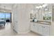 Hallway featuring a vanity, and a partial view to the bright main bedroom with a water view at 600 Bayway Blvd # 504, Clearwater Beach, FL 33767