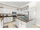 Bright kitchen with an island, granite counters, stainless steel appliances, and plenty of cabinets for storage at 600 Bayway Blvd # 504, Clearwater Beach, FL 33767