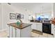 Well-lit kitchen featuring granite counters, white cabinets, and modern appliances, creating a functional and stylish space at 600 Bayway Blvd # 504, Clearwater Beach, FL 33767