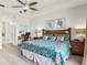 Bright main bedroom featuring wood floors, a ceiling fan, and light walls at 600 Bayway Blvd # 504, Clearwater Beach, FL 33767