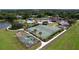 Aerial view showcasing community amenities including sports courts, pool, clubhouse, and lush landscaping at 6931 Surrey Hill Pl, Apollo Beach, FL 33572