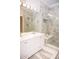 Elegant bathroom featuring a luxurious marble shower, modern vanity, and stylish fixtures at 6931 Surrey Hill Pl, Apollo Beach, FL 33572