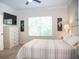 Bright bedroom with large windows, stylish decor, and cozy carpet flooring at 6931 Surrey Hill Pl, Apollo Beach, FL 33572