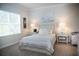 Bright bedroom with a comfortable bed, neutral decor, and soft lighting creating a serene atmosphere at 6931 Surrey Hill Pl, Apollo Beach, FL 33572