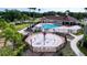 Community pool featuring a splash pad, flower-shaped water fountains and ample deck space at 6931 Surrey Hill Pl, Apollo Beach, FL 33572