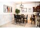 Cozy dining area features a stylish table set, modern lighting, and decor that enhances the space's aesthetic appeal at 6931 Surrey Hill Pl, Apollo Beach, FL 33572