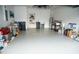 Spacious garage with epoxy flooring, water filtration system, and ample storage space at 6931 Surrey Hill Pl, Apollo Beach, FL 33572