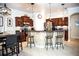 A spacious kitchen includes dark cabinets, stainless steel appliances, bar seating, and modern pendant lighting at 6931 Surrey Hill Pl, Apollo Beach, FL 33572